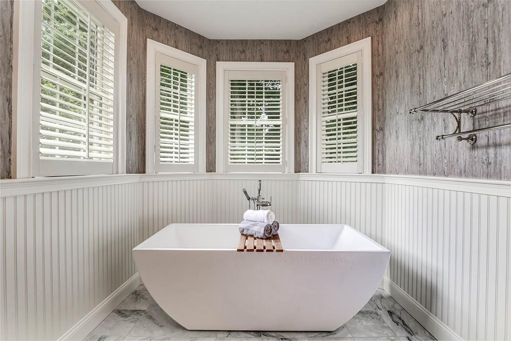 63 Ardmore Road Needham, MA 02494 - Photo 25 of 41 a white bath tub sitting in a bathroom next to a window