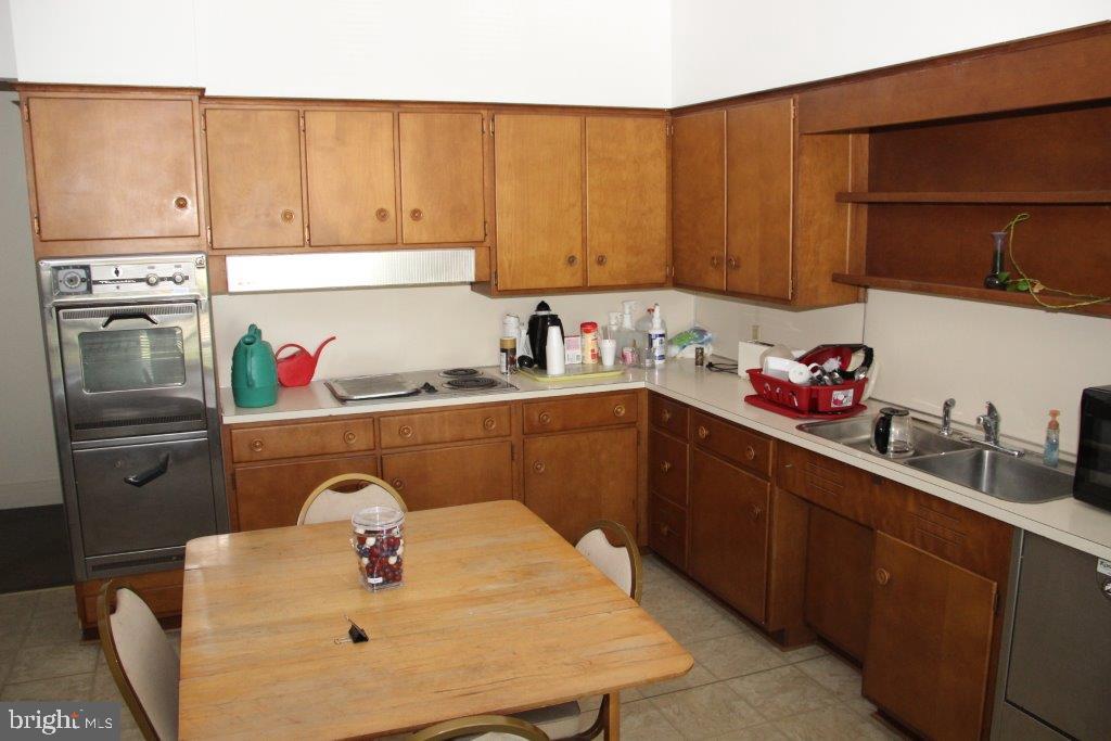 1720 Mineral Spring Road Reading, PA 19602 - Photo 18 of 26 a kitchen with a sink a stove and cabinets