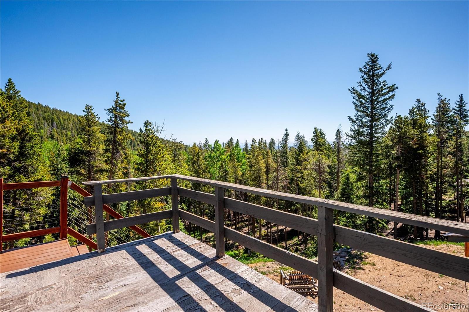 1633 Sinton Road Evergreen, CO 80439 - Photo 20 of 50 a view of a balcony with wooden fence and floor