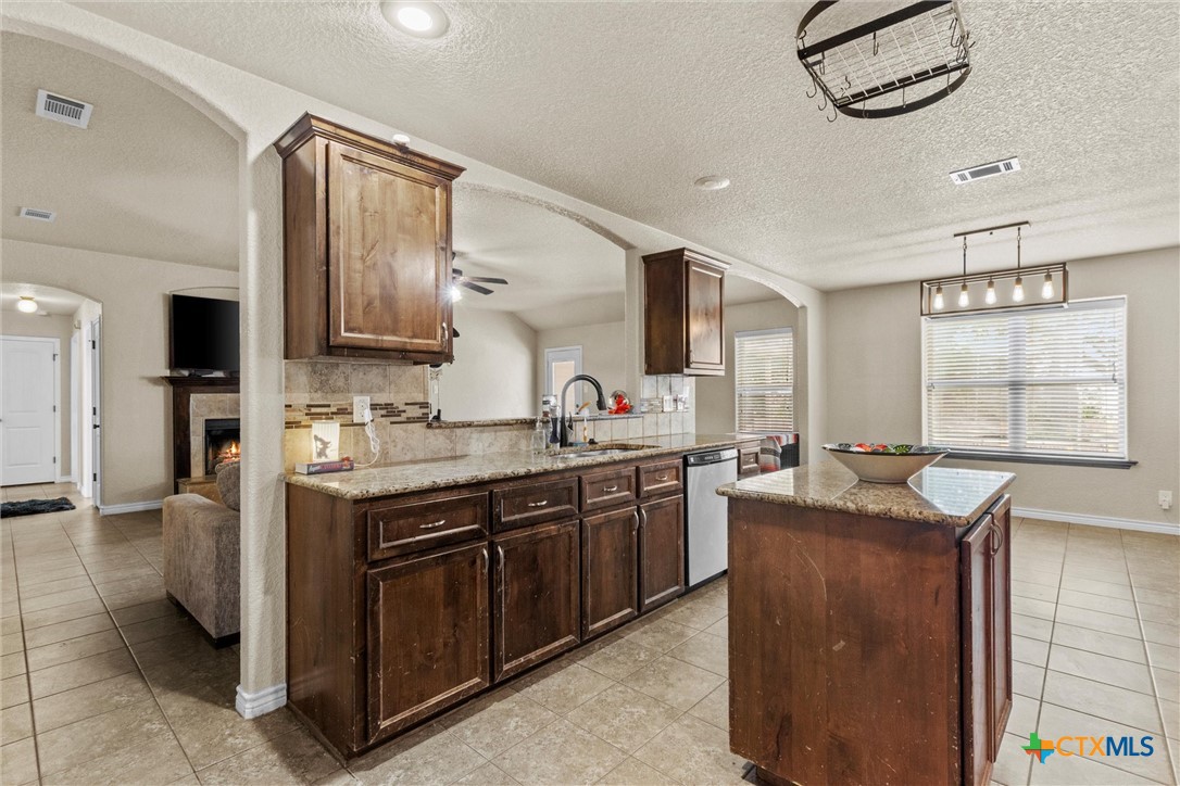 6405 Deorsam Loop Killeen, TX 76542 - Photo 12 of 36 a kitchen with stainless steel appliances granite countertop a sink and a stove