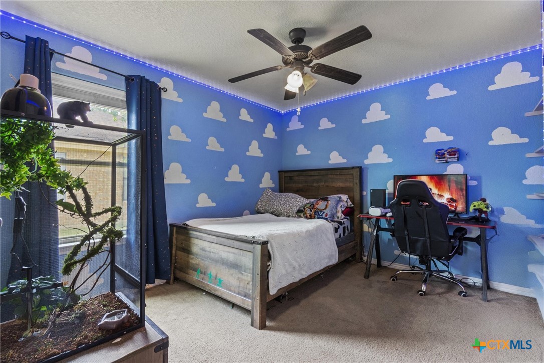 6405 Deorsam Loop Killeen, TX 76542 - Photo 20 of 36 a bedroom with a bed and a chandelier