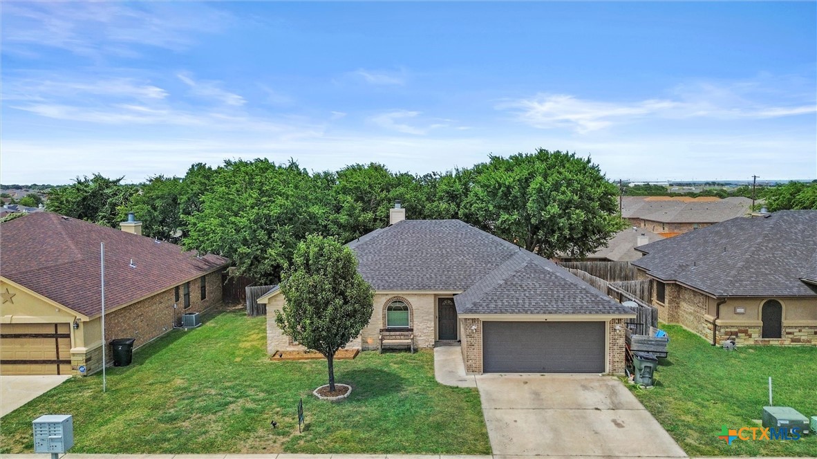 6405 Deorsam Loop Killeen, TX 76542 - Photo 29 of 36 a front view of a house with a yard and garage