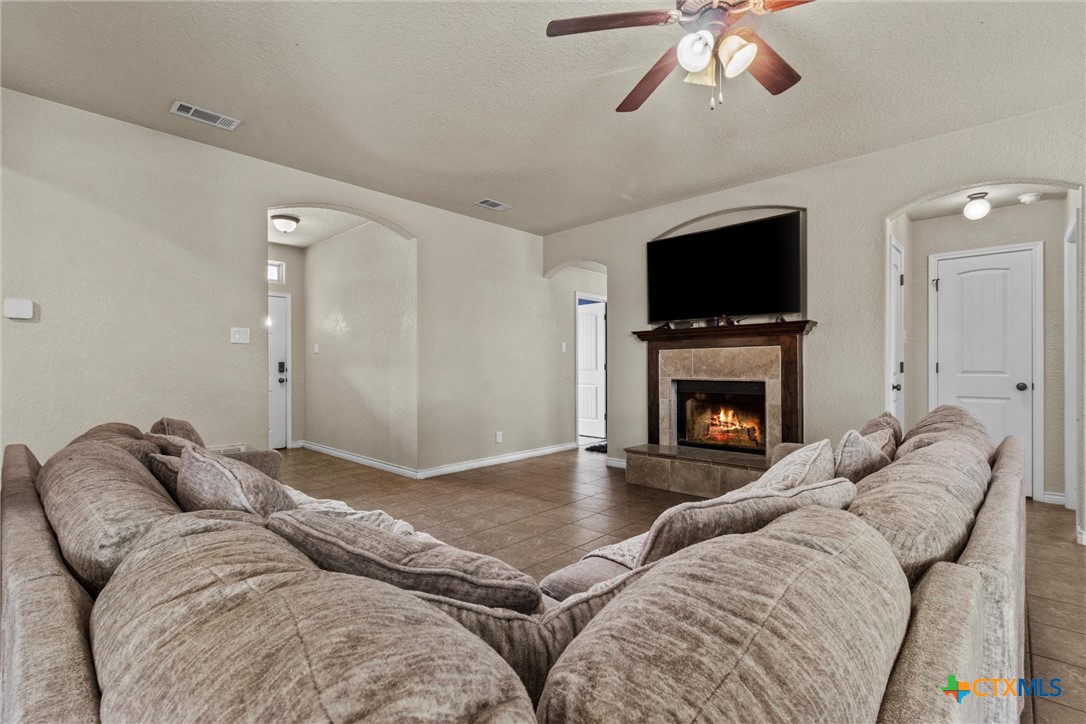 6405 Deorsam Loop Killeen, TX 76542 - Photo 4 of 36 a living room with furniture a flat screen tv and a fireplace
