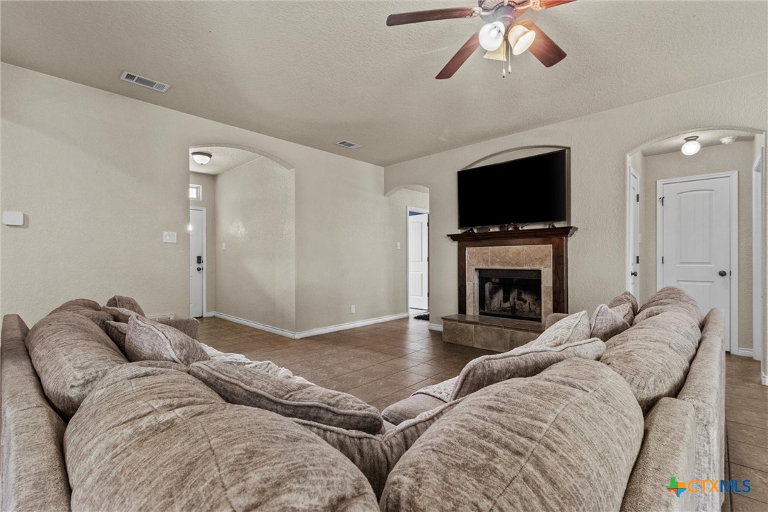 6405 Deorsam Loop Killeen, TX 76542 - Photo 5 of 36 a living room with furniture a flat screen tv and a fireplace