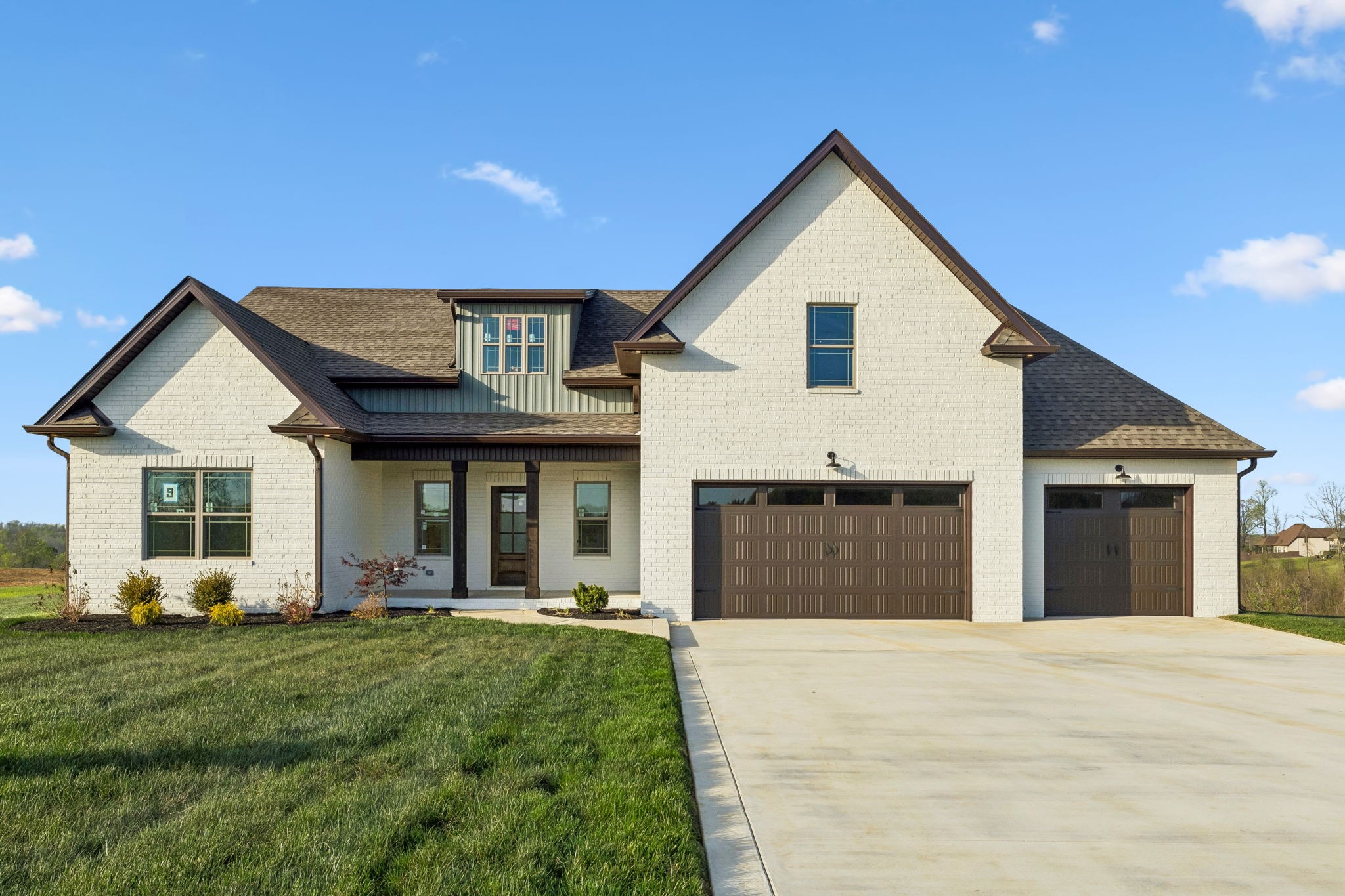 1015 Linder Ridge Road Woodlawn, TN 37191 - Photo 1 of 55 a front view of a house with a yard and garage