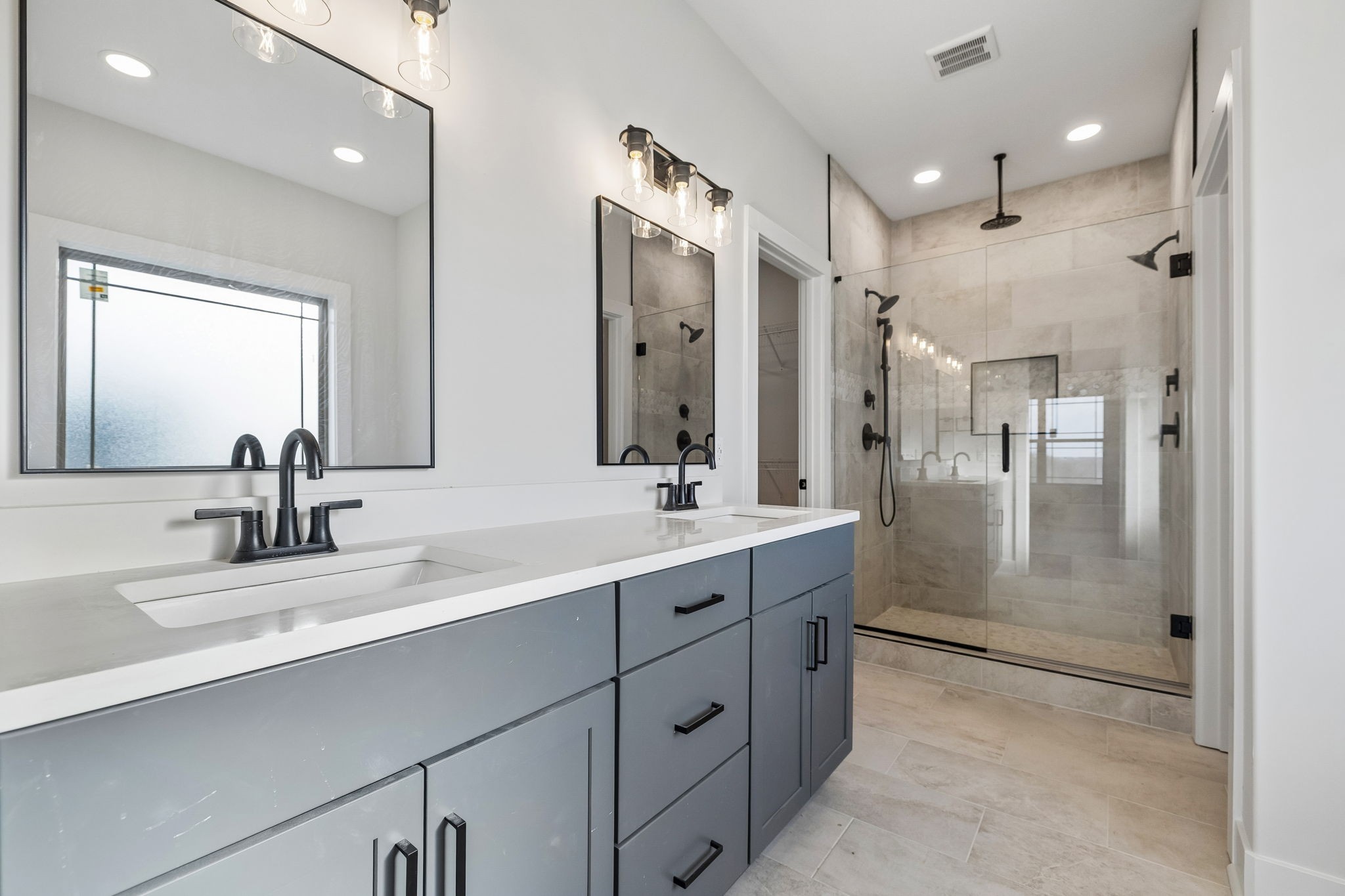 1015 Linder Ridge Road Woodlawn, TN 37191 - Photo 28 of 55 a bathroom with a double vanity sink mirror and shower