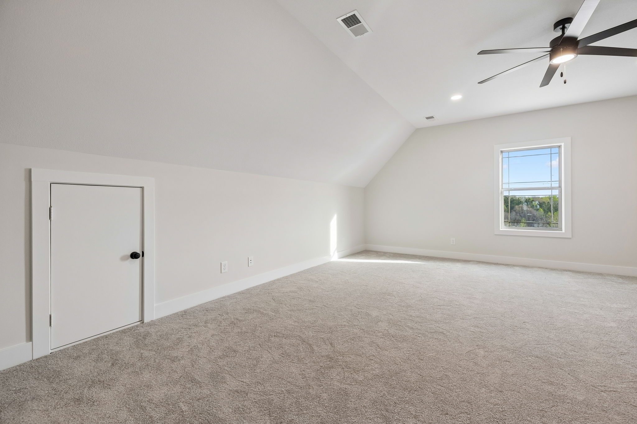 1015 Linder Ridge Road Woodlawn, TN 37191 - Photo 34 of 55 an empty room with a ceiling fan and windows