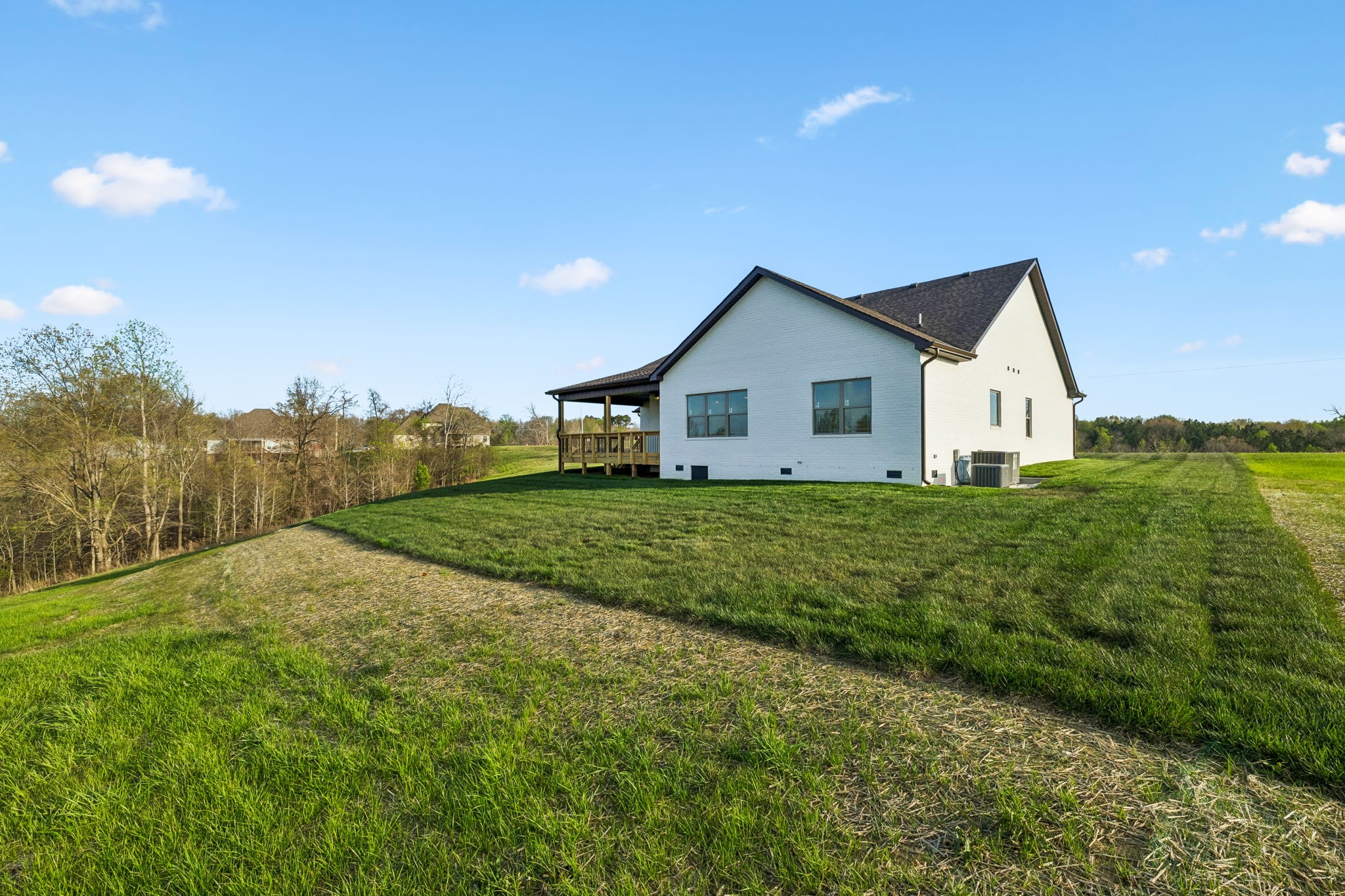 1015 Linder Ridge Road Woodlawn, TN 37191 - Photo 49 of 55 a view of a house with a big yard and large tree