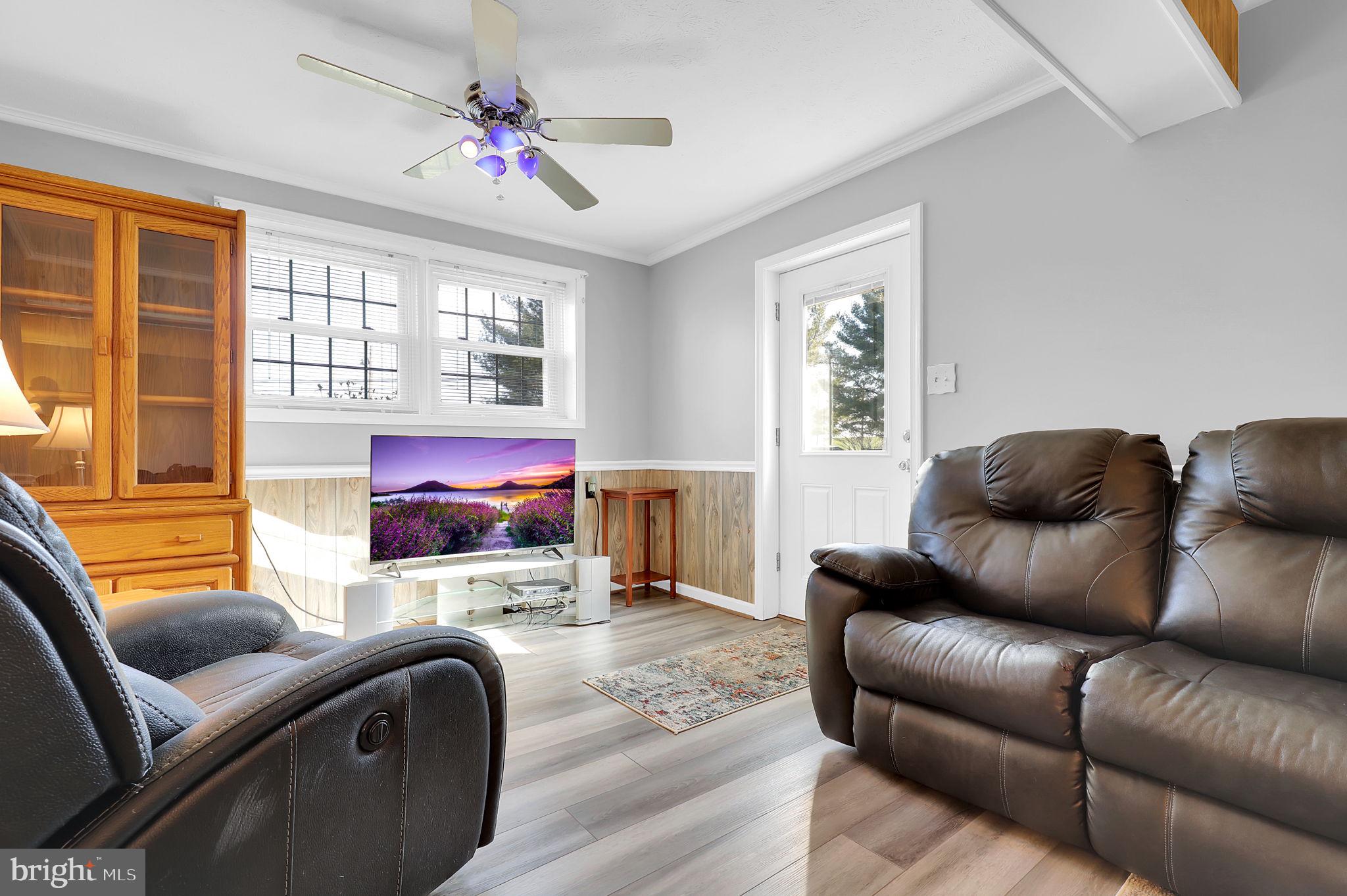 5709 Adamstown Road Adamstown, MD 21710 - Photo 20 of 42 a living room with furniture ceiling fan and a window