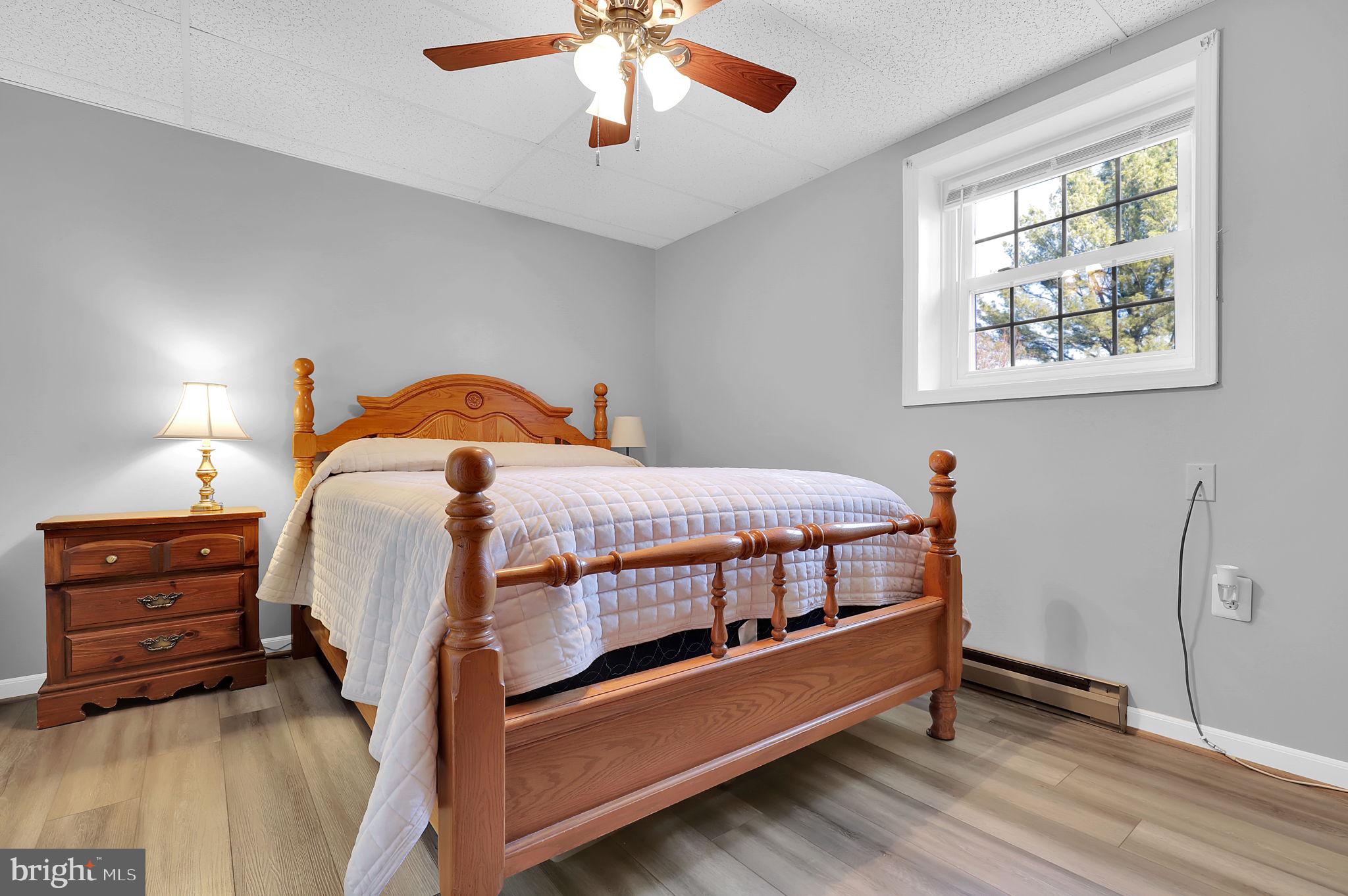 5709 Adamstown Road Adamstown, MD 21710 - Photo 23 of 42 a bedroom with a bed and a chandelier