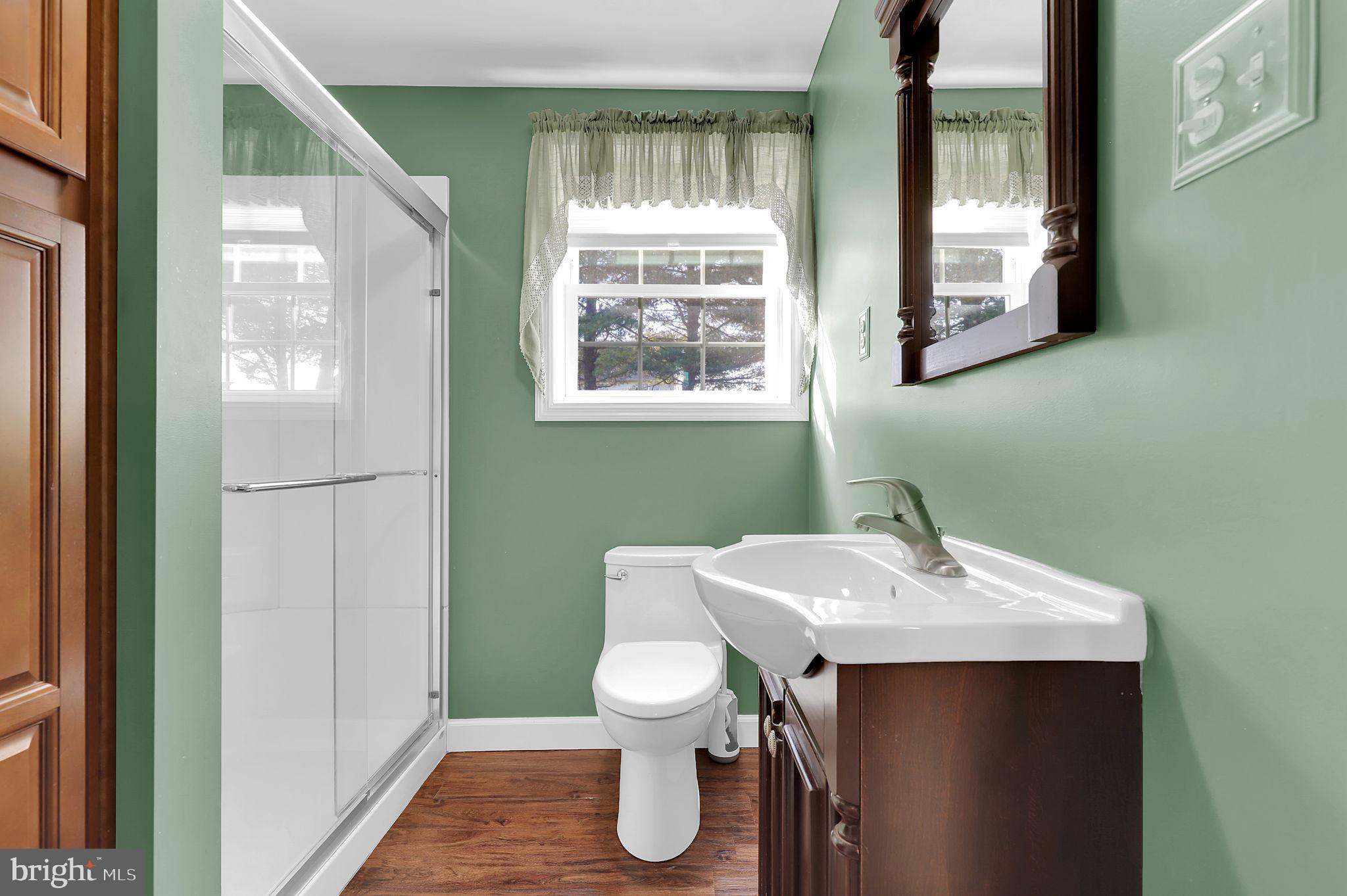 5709 Adamstown Road Adamstown, MD 21710 - Photo 24 of 42 a bathroom with a toilet sink and mirror
