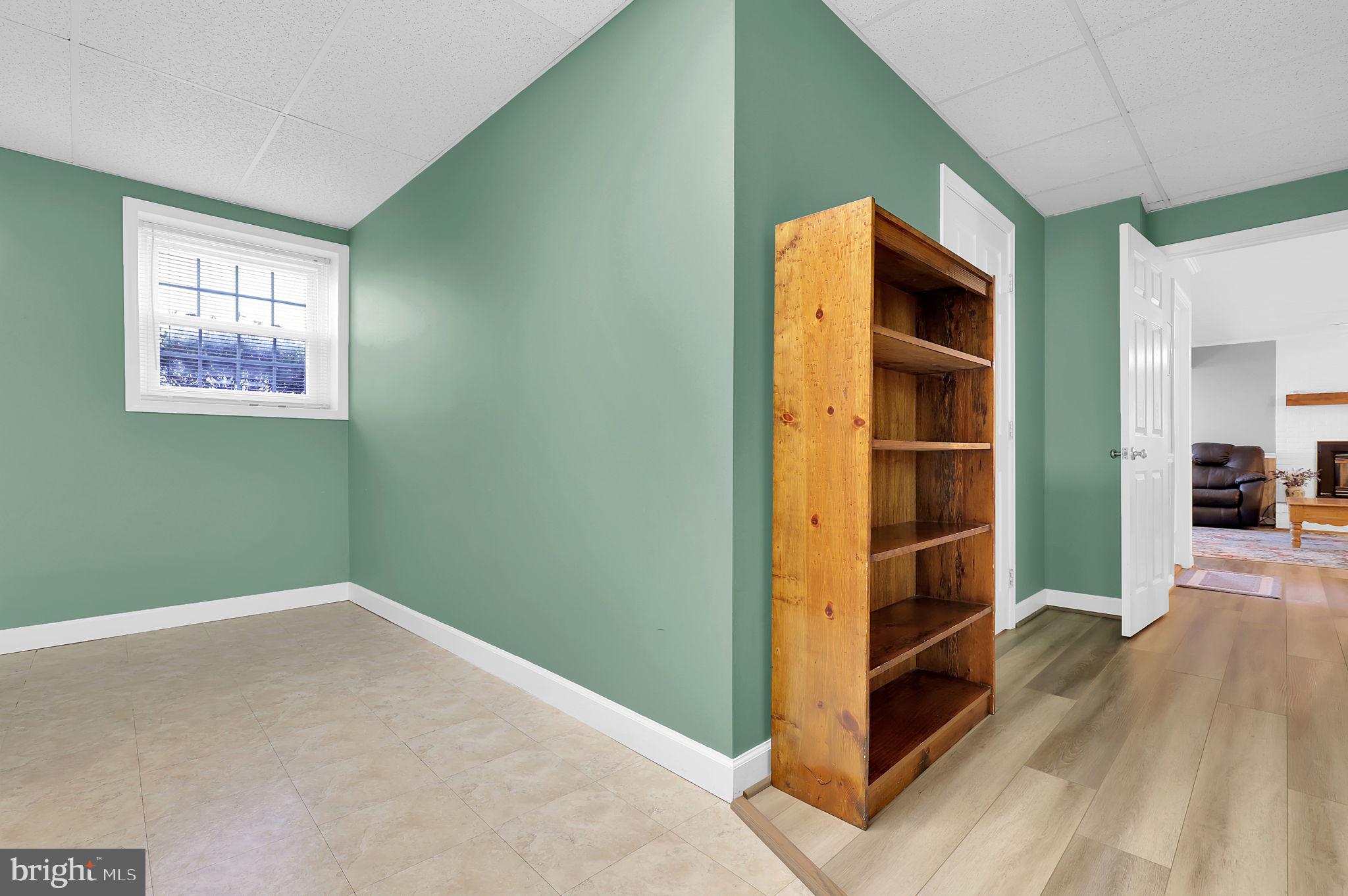 5709 Adamstown Road Adamstown, MD 21710 - Photo 25 of 42 an empty room with wooden floor and windows