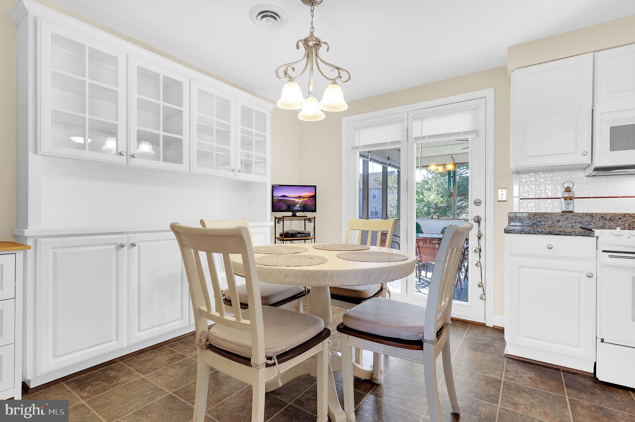 5709 Adamstown Road Adamstown, MD 21710 - Photo 8 of 42 a view of a dining room with furniture window and wooden floor