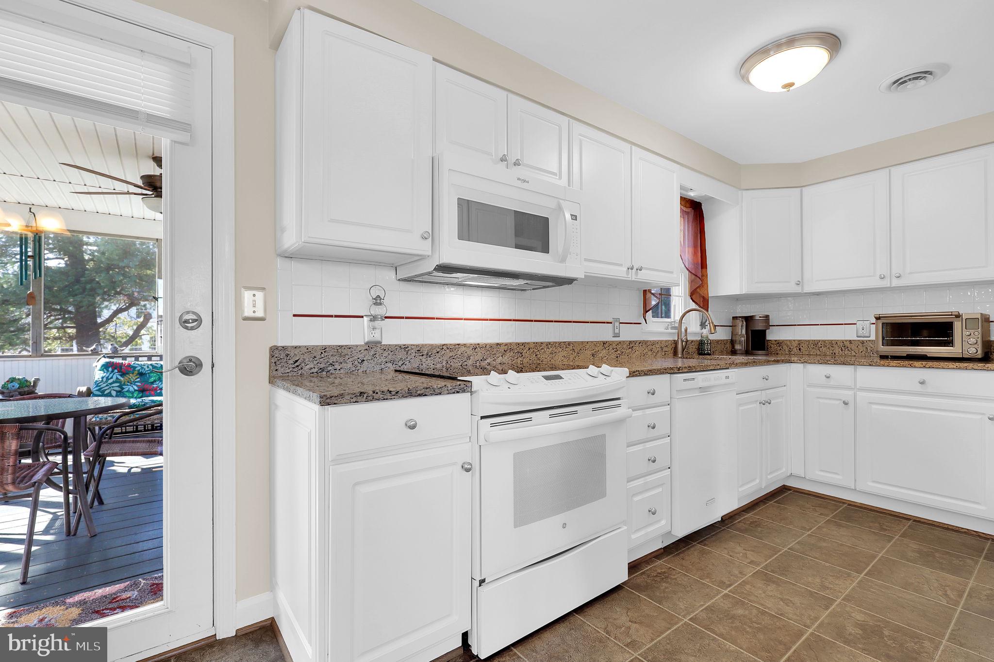5709 Adamstown Road Adamstown, MD 21710 - Photo 10 of 42 a kitchen with granite countertop white cabinets white appliances and a granite counter tops