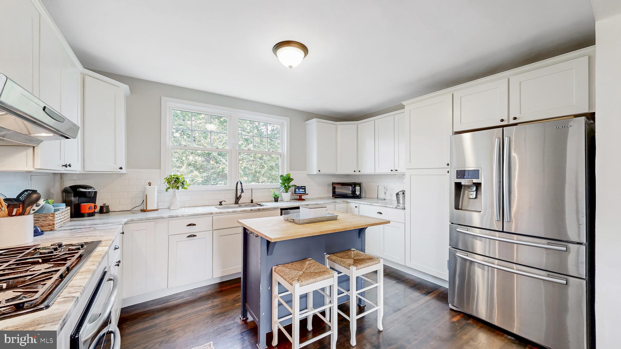 226 Bowers Beach Road Frederica, DE 19946 - Photo 21 of 46 a kitchen with stainless steel appliances a refrigerator sink and wooden floor