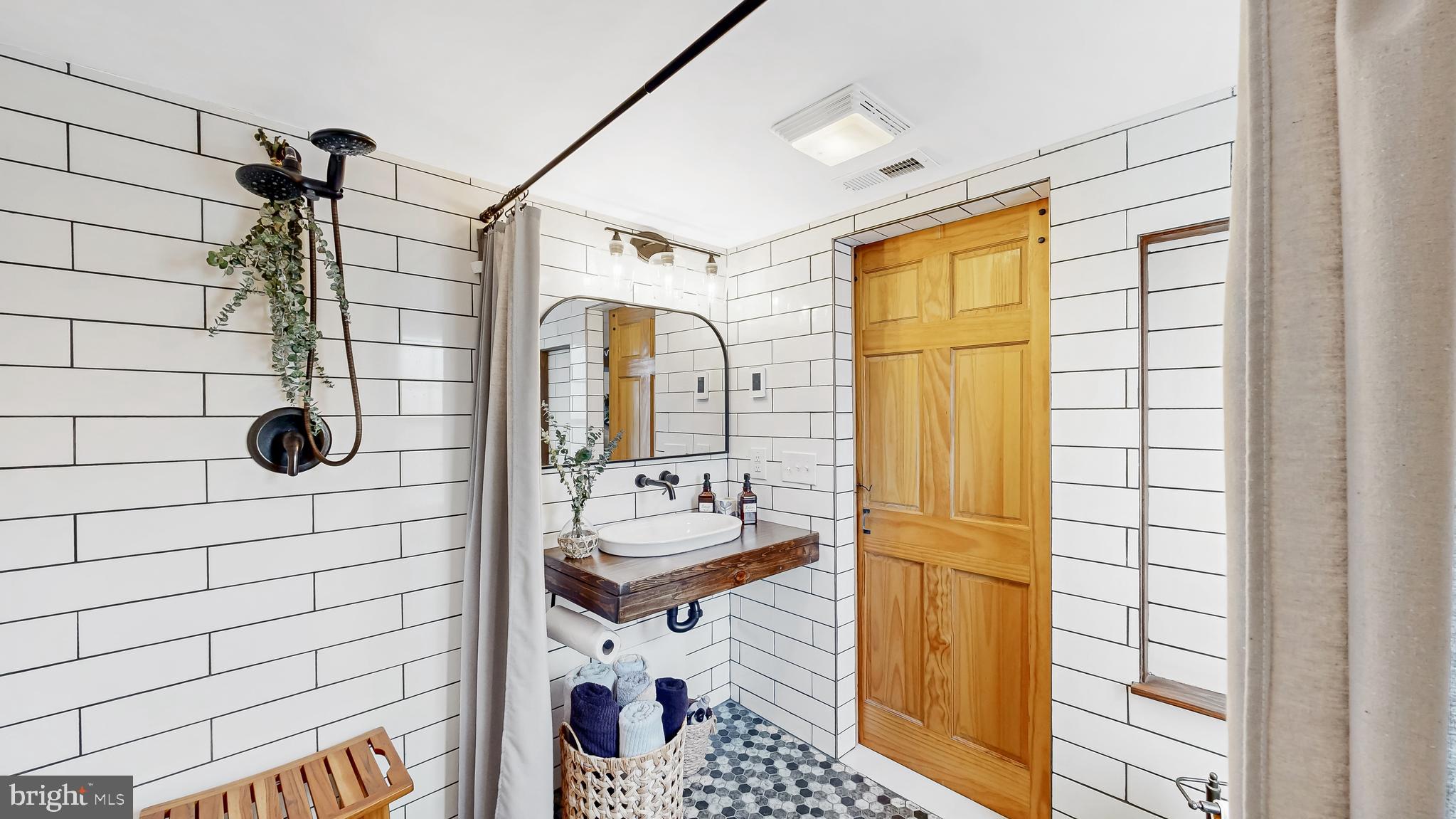 226 Bowers Beach Road Frederica, DE 19946 - Photo 23 of 46 a bathroom with a sink mirror and shower