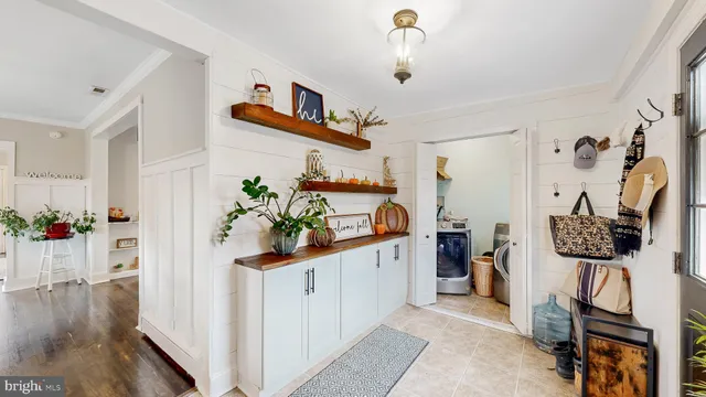 a hallway with a book shelf and wooden floor