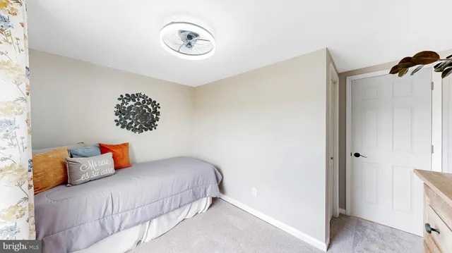 a bedroom with a bed and a potted plant