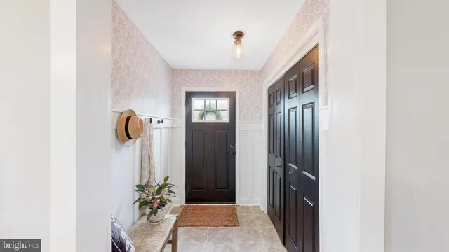 a view of a hallway with potted plant in front of door