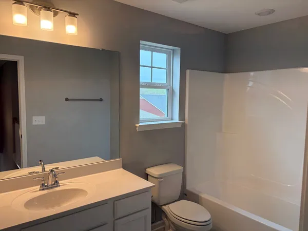 a bathroom with a sink toilet and vanity