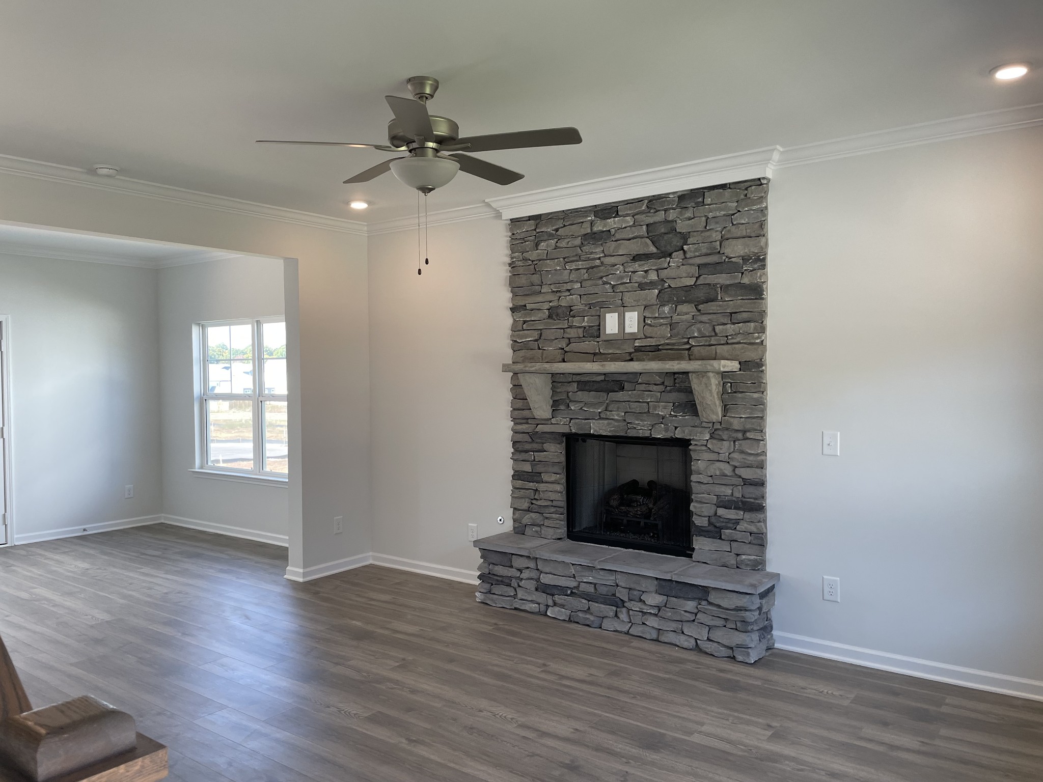 7021 Sully Court Fairview, TN 37062 - Photo 2 of 6 a view of an empty room with wooden floor fireplace and a window