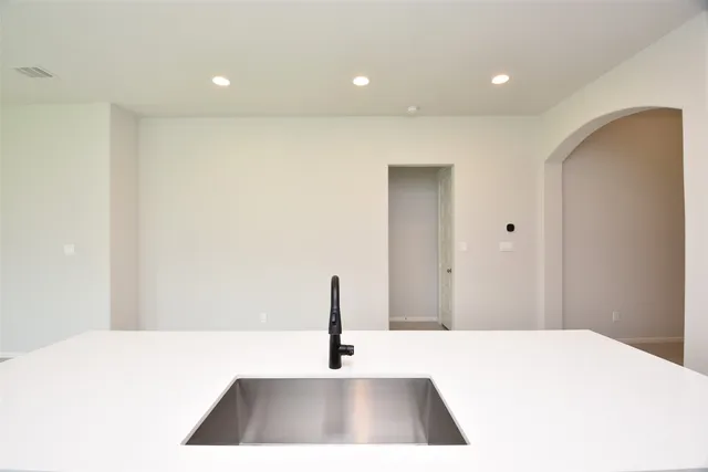 a kitchen with granite countertop a sink and cabinets