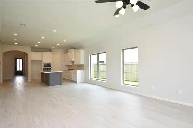 a bathroom with a tub a sink and a window