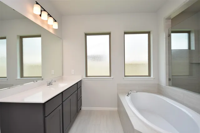 a bathroom with a glass shower door