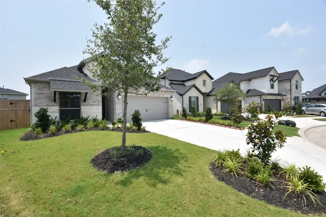 a house with green field in front of it