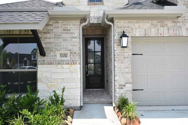 a front view of a house with a door and balcony