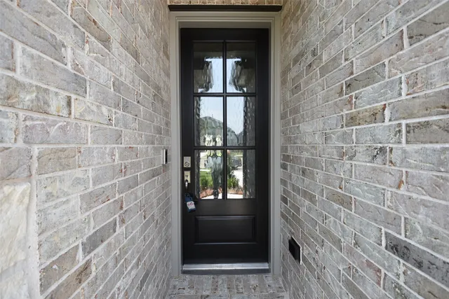 a front view of a house with plants