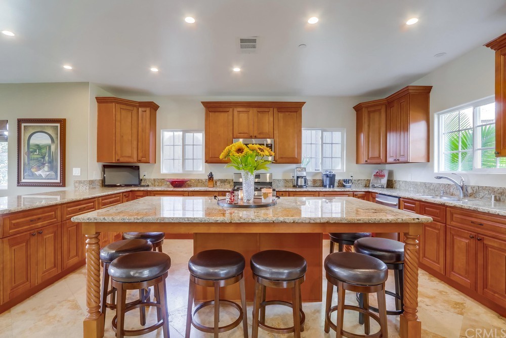 a kitchen with granite countertop counter space dining table and stainless steel appliances