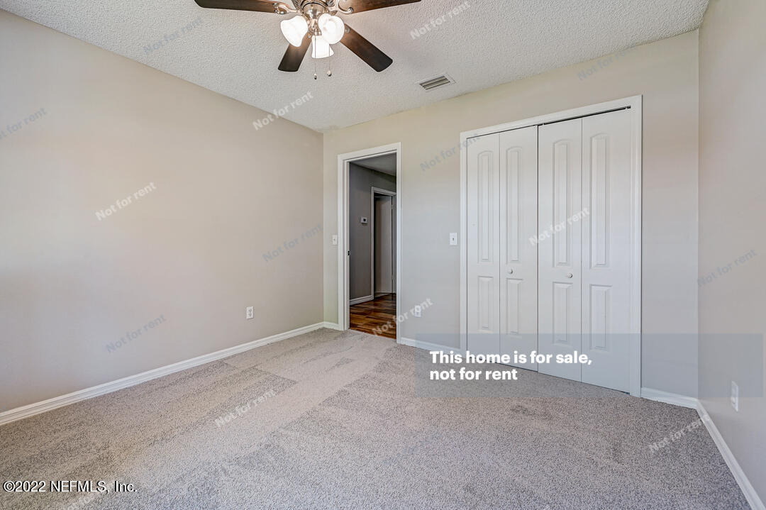 416 Shamrock Road St. Augustine, FL 32086 - Photo 12 of 29 a view of an empty room and chandelier fan