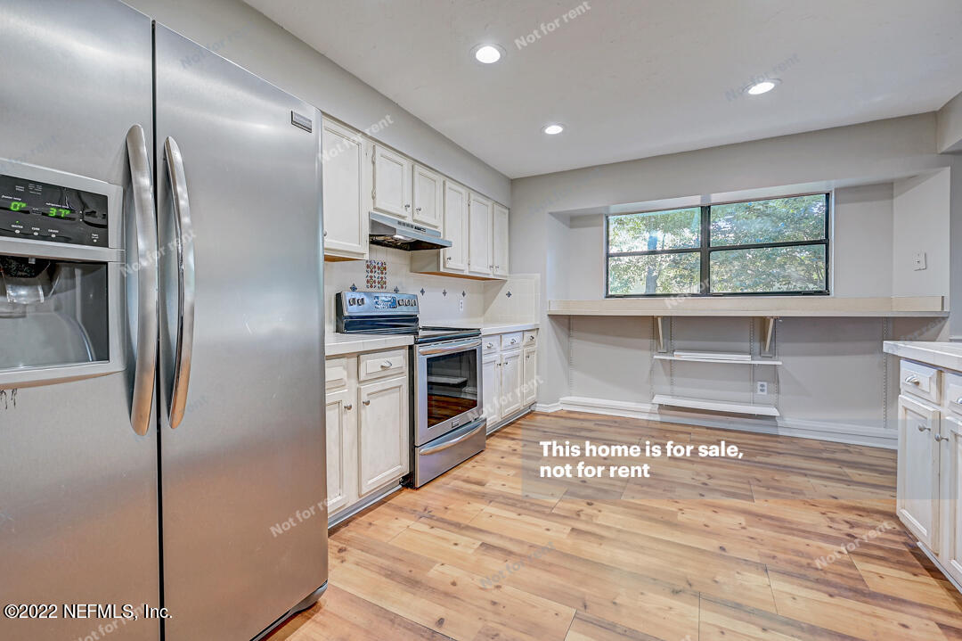 416 Shamrock Road St. Augustine, FL 32086 - Photo 2 of 29 a kitchen with stainless steel appliances granite countertop a refrigerator a stove and a sink with wooden floor
