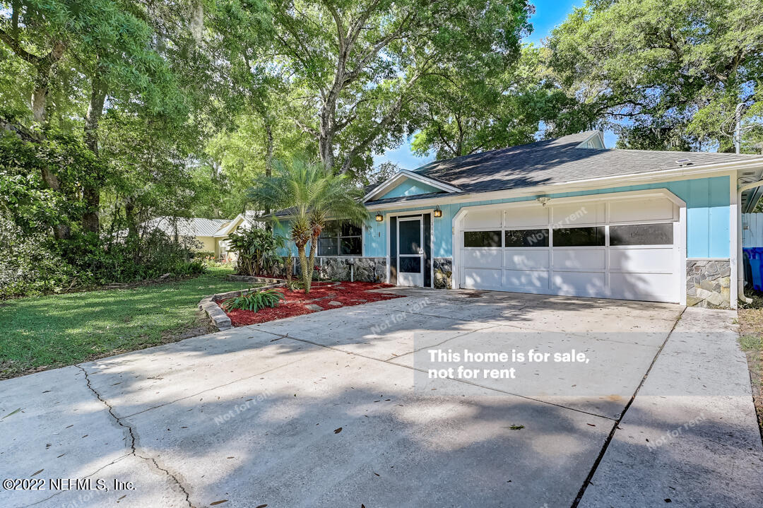 416 Shamrock Road St. Augustine, FL 32086 - Photo 23 of 29 a view of a white house with a large tree and plants