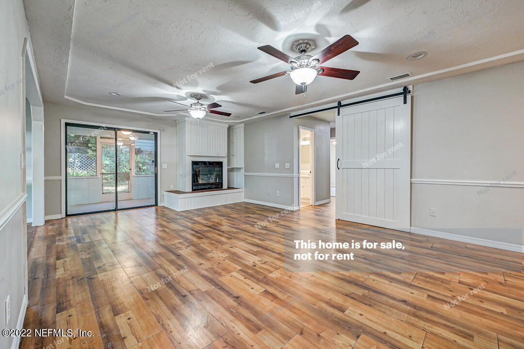 416 Shamrock Road St. Augustine, FL 32086 - Photo 3 of 29 a view of a livingroom with a ceiling fan window and wooden floor