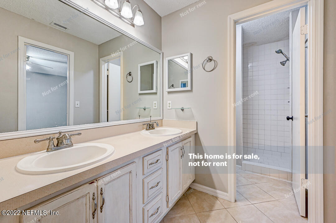 416 Shamrock Road St. Augustine, FL 32086 - Photo 4 of 29 a spacious bathroom with a double vanity sink mirror and shower