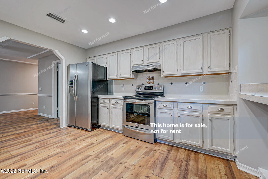 416 Shamrock Road St. Augustine, FL 32086 - Photo 6 of 29 a kitchen with stainless steel appliances granite countertop a stove a refrigerator and a microwave