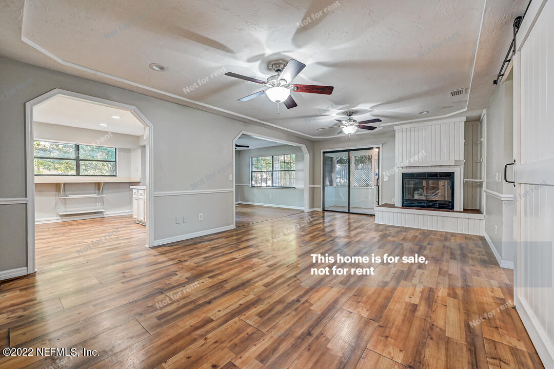 416 Shamrock Road St. Augustine, FL 32086 - Photo 9 of 29 wooden floor in an empty room with a fireplace