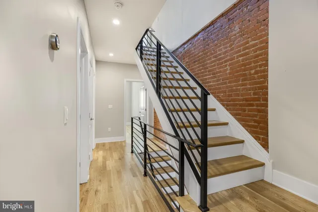 a view of entryway with wooden floor and stairs