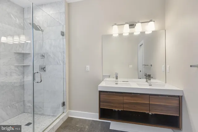 a bathroom with a sink a mirror and shower