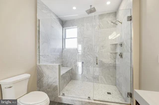 a bathroom with a shower and toilet