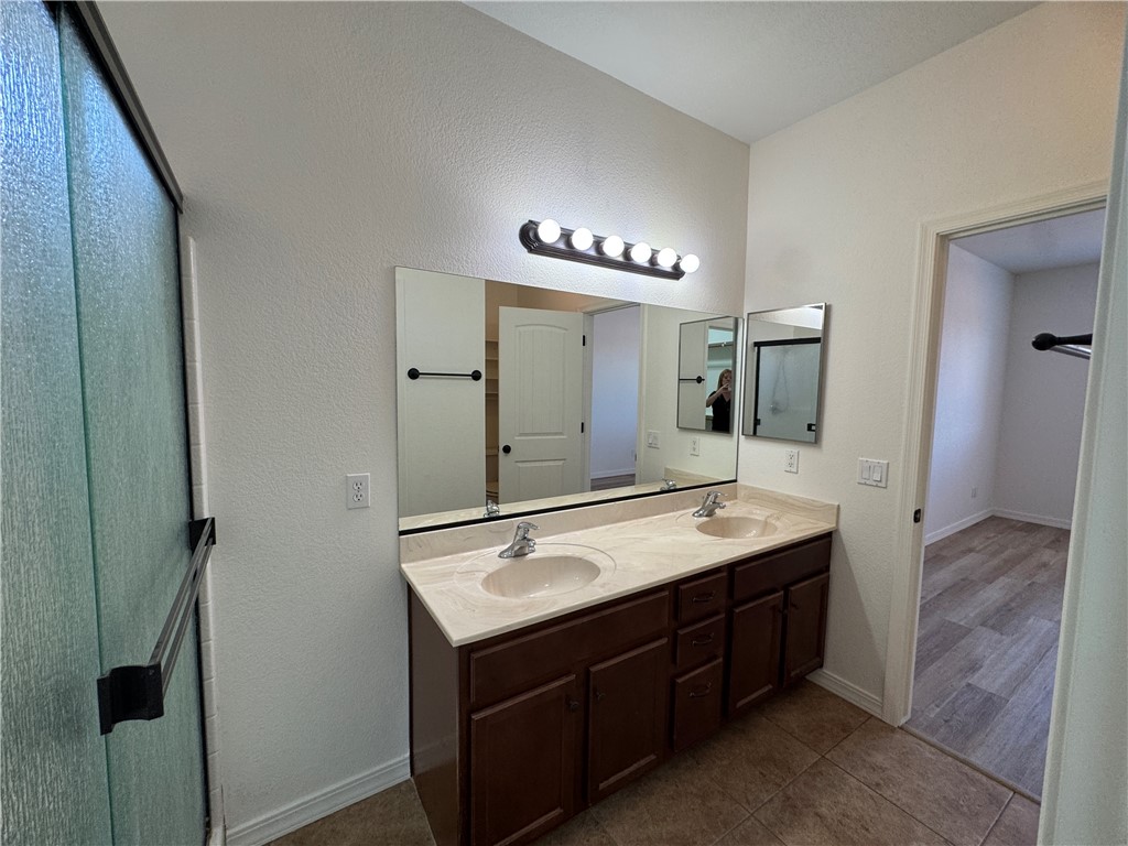 4263 East Medicine Bend Road Kingman, AZ 86401 - Photo 13 of 14 a spacious bathroom with a double vanity sink and a mirror