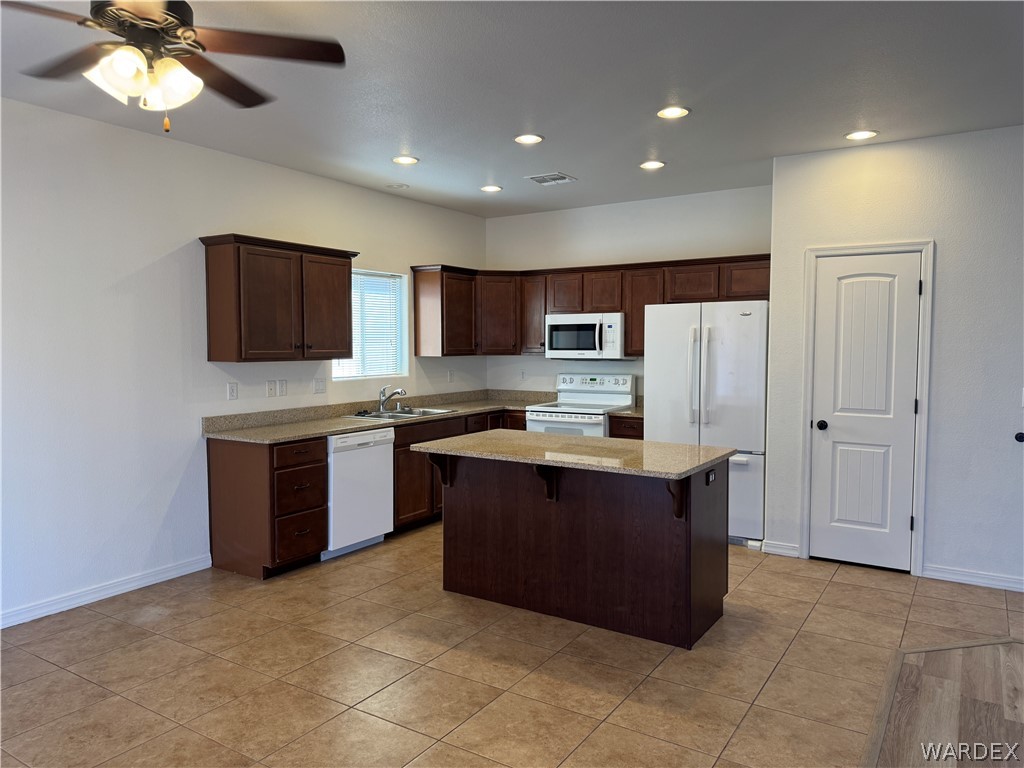 4263 East Medicine Bend Road Kingman, AZ 86401 - Photo 7 of 14 a large kitchen with stainless steel appliances granite countertop a refrigerator and a stove top oven