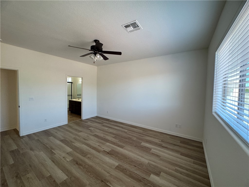4263 East Medicine Bend Road Kingman, AZ 86401 - Photo 9 of 14 a view of empty room with wooden floor and window