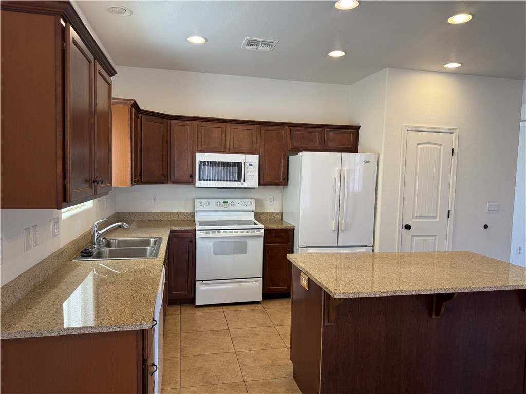4263 East Medicine Bend Road Kingman, AZ 86401 - Photo 10 of 14 a kitchen that has a sink and a stove in it