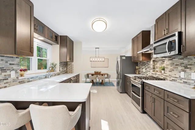 a bathroom with a granite countertop sink a mirror and shower