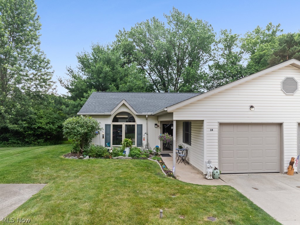 808 Ryan Road, Unit 14 Medina, OH 44256 - Photo 2 of 40 Single-story residence featuring light-colored siding, a dark shingle roof, and an integrated garage with a panel door