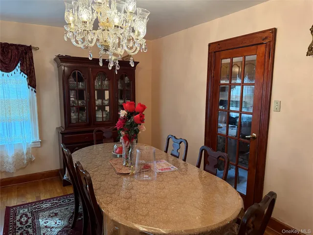 a kitchen with a table chairs sink and cabinets
