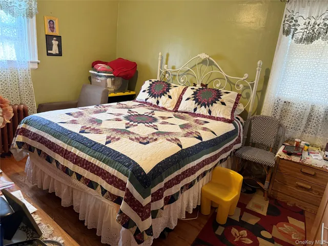 a bed sitting in a bedroom next to a window